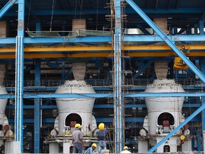 In this Feb. 24, 2015 file photo, boilers are installed at a coal-fired power plant, partially financed by the Japan Bank for International Cooperation, under construction in Kudgi, India. A compromise struck by the United States, Japan and several other major nations will restrict export financing to build coal power plants overseas, but not eliminate it completely. The agreement reached Tuesday, Nov. 17 is an important step forward that sends a strong political message ahead of upcoming international climate change negotiations in Paris, an American official and environmentalists said. (AP Photo/Aijaz Rahi, File)