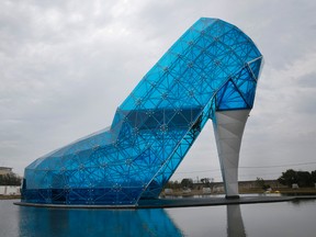 This Jan. 28, 2016 photo shows a giant glass structure shaped like a high-heel shoe being built as a wedding hall in southern Chiayi, Taiwan. The shoe honors women who suffered from arsenic poisoning from well water that caused gangrene, a condition sometimes known as "black feet disease." (AP Photo/Wally Santana)