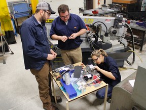 Supplied photo 
Students Lucas Dermott, Brent Cowling, and Julia Kocis work on an applied research project in the machining shop at Cambrian College.