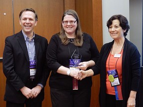 Pierre Elliott Trudeau French Immersion teacher/librarian Dawn Telfer, middle, accepts the 2015 Ontario School Library AssociationTeacher Librarian of the Year award at a ceremony last Thursday in Toronto. The annual award recognizes teacher/librarians who contribute to experiential learning and innovation within their schools.