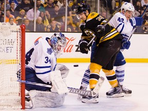 Boston Bruins left wing Loui Eriksson (21) and Toronto Maple Leafs center Tyler Bozak (42) battle for a loose puck in front of Toronto Maple Leafs goalie James Reimer (34) during the third period of the Boston Bruins 2-1 win over the Toronto Maple Leafs at TD Garden. Mandatory Credit: Winslow Townson-USA TODAY Sports
