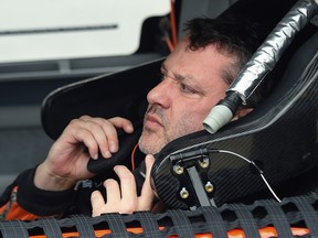 In this Oct. 24, 2015, file photo, driver Tony Stewart unbuckles from his car after qualifying for the NASCAR Sprint Cup Series auto race at Talladega Superspeedway in Talladega, Ala. (AP Photo/ Mark Almond, File)
