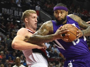 Sacramento Kings centre DeMarcus Cousins (15) drives to the basket on Portland Trail Blazers centre Mason Plumlee (24) during the first half of an NBA game in Portland, Ore., Tuesday, Jan. 26, 2016. (AP Photo/Steve Dykes)