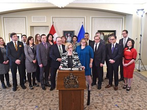 Premier Rachel Notley speaking to the media with her increased in size cabinet in back after announcing six new cabinet minister Tuesday during a ceremony at Government House in Edmonton, February 2, 2016. ED KAISER/Postmedia