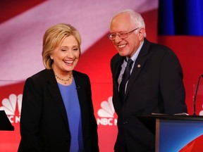 Democratic presidential candidates Hillary Clinton and Sen. Bernie Sanders during a break at the NBC, YouTube Democratic presidential debate Jan. 17, 2016, in Charleston, S.C. (AP Photo/Mic Smith)