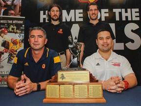 Queen’s coach Brett Gibson, left, Gaels goalie Kevin Bailie, Royal Military College Paladins forward Eric Louis-Seize and RMC coach Richard Lim attend a news conference for the 30th Carr-Harris Cup hockey game at the Alumni Lounge at Queen’s University’s Athletics and Recreation Centre on Tuesday. (Julia McKay/The Whig-Standard)