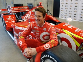Scott Dixon poses with a new paint design on his race car during an IndyCar news conference at the Indianapolis Motor Speedway Tuesday, Feb. 2, 2016, in Indianapolis. (AP Photo/Darron Cummings)