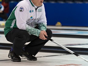 Mike Harris of the Toronto Cricket Skating and Curling Club watches after throwing a rock during play at the 2016 Ontario men’s Tankard in Brantford. (BRIAN THOMPSON/Postmedia Network)