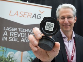 Jacques Nault shows off Laser Ag’s laser soil analysis system at the 2016 Precision Agriculture Conference in London Tuesday. (CRAIG GLOVER, The London Free Press)