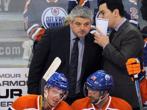 Connor McDavid and Jordan Eberle talk on the bench as coach Todd McLellan watches the play during the first period of Tuesday's game at Rexall Place. (Dan Riedlhuber)