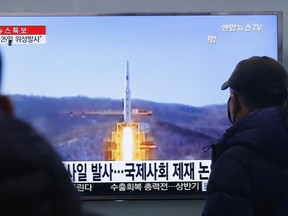 South Koreans watch a TV news program with a file footage about North Korea's rocket launch plans, at Seoul Railway Station in Seoul, South Korea, Wednesday, Feb. 3, 2016. South Korea warned on Wednesday of "searing" consequences if North Korea doesn't abandon plans to launch a long-range rocket that critics call a banned test of ballistic missile technology.  The headline on the screen reads "North Korea plans to launch a missile." (AP Photo/Ahn Young-joon)