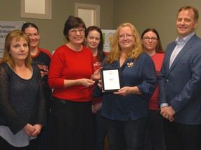 Ontario Trillium Foundation volunteer Diane Dubois, second left, Hospice Outreach Programs of Elgin executive director Cindy Webber and Elgin-Middlesex-London MPP Jeff Yurek celebrate the receipt of a $75,000 provincial grant at a reception and plaque presentation Tuesday morning. The grant will fund community outreach and educational programs to target child and youth grief.