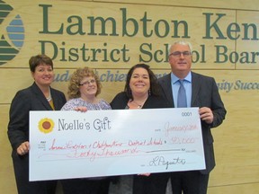 From left, principals Helen Lane and Sandra Perkins, Jackie Major-Daamen from the Noelle's Gift Foundation, and educator director Jim Costello, are shown with a $40,000 donation the foundation made to the school board on Wednesday February 3, 2016 in Sarnia, Ont. The money is used by schools to meet the needs of students and families.
(Paul Morden, The Observer)