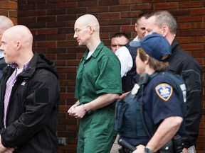 David Sweat, center, is lead out of the Clinton County Government Building in Plattsburgh, N.Y. by correctional officers following his sentencing Wednesday Feb. 3, 2016. (Gabe Dickens/Press-Republican via AP)