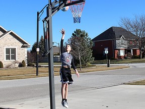 Evan McGregor, 14, of Chatham, was drawn outdoors by sunny skies and 12 C to shoot some hoops in his neighbourhood and enjoy wearing shorts on the warmest day this year on Wednesday February 3, 2016 in Chatham, Ont. (Vicki Gough, The Daily News)