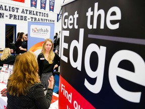 Tim MIller/ The Intelligencer
Megan Brown, employment services at Career Edge, speaks with a visitor to their booth at Loyalist College's Career Fair on Wednesday. The organization was there looking to fill an open job development role in Napanee as well as recruiting summer staff for a new job connection program.