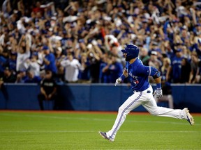 Blue Jays' Jose Bautista rounds the bases after a ground rule double against the Royals during Game 5 of the ALCS at the Rogers Centre in Toronto on Oct. 21, 2015. The Blue Jays will begin installing a dirt infield at Rogers Centre next week that will be ready for the 2016 season. (Craig Robertson/Toronto Sun)