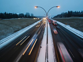 Traffic makes its way along Whitemud Drive, as seen from 121 Street, on a snowy evening in Edmonton, Alta., on Monday, Nov. 23, 2015. Codie McLachlan/Postmedia Network