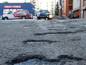 Potholes are already visible in an alley south of Jasper Avenue and 119 Street, in Edmonton Alta. on Wednesday Feb. 3, 2016. Photo by David Bloom