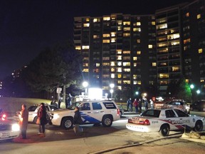 Police at the scene of a fatal stabbing behind a residential building on The West Mall Wednesday, Feb. 3, 2016. (PASCAL MARCHAND PHOTO)