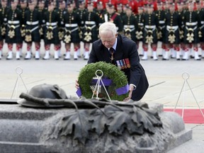 Governor General David Johnston lays a wreath during a ceremony to commemorate the October 2014 attack on Parliament Hill, at the National War Memorial in Ottawa on October 22, 2015. After deadly shootings on Parliament Hill in 2014 and at a casino in St. Albert, Alta., last year, changes are being made to the role of auxiliary RCMP constables. REUTERS/Chris Wattie