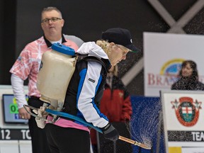 Icemaker Lou Anne Pauhl, who was diagnosed with Parkinson’s disease in 2008, applies pebble to the ice on Feb. 3, 2016, at the Ontario men’s Tankard in Brantford. (BRIAN THOMPSON/Postmedia Network)