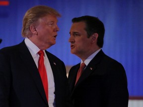 Republican U.S. presidential candidate businessman Donald Trump and rival candidate Sen. Ted Cruz, right, cross paths during a break at the Fox Business Network Republican presidential candidates debate in North Charleston, S.C., on Jan. 14, 2016. (REUTERS/Chris Keane)