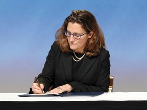Canada’s International Trade Minister Chrystia Freeland signs the Trans-Pacific Partnership Agreement in Auckland, New Zealand, on Feb. 4, 2016. Trade ministers from 12 Pacific Rim countries including the United States have ceremonially signed the free-trade deal. (David Rowland/SNPA via AP)