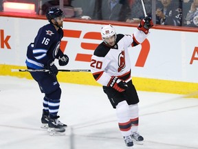 Devils forward Lee Stempniak (right) celebrates his goal as Jets forward Andrew Ladd (left) skates by during NHL action in Winnipeg on Jan. 23, 2016. (John Woods/THE CANADIAN PRESS)