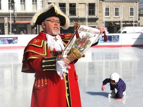 A young skater tries to regain her feet as town crier Chris Whyman officially kicks off this year's FebFest during a ceremony in the Springer Market Square rink. (Michael Lea/The Whig-Standard)