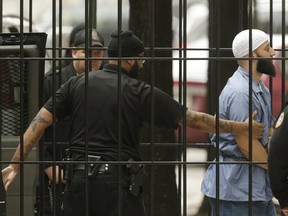 Convicted murderer Adnan Syed (R) arrives at the Baltimore City Circuit Courthouse in Baltimore, Maryland February 4, 2016. The Maryland man whose 2000 murder conviction was thrown into question by the popular "Serial" podcast was in court today to argue he deserved a new trial because his lawyers had done a poor job with his case. REUTERS/Gary Cameron