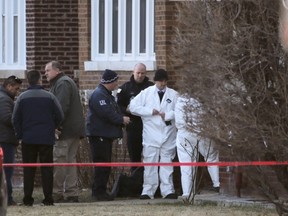 Chicago police investigators prepare to enter a home where bodies were found after police performed a well being check Thursday, Feb. 4, 2016, in Chicago. Interim police Superintendent John Escalante told reporters the bodies of four men, one woman and a child have been found inside a home on the city's South Side in what Escalante said could be a murder-suicide. Escalante says police entered the house in Chicago's Gage Park neighborhood after receiving a call from a co-worker to check on a man who lived there. He missed two days of work, which was unusual. (AP Photo/Charles Rex Arbogast)
