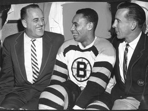 Telefiles pic of Willie O'Ree, middle, shown with Boston Bruin general manager Lynn Patrick, left, and coach Milt Schmidt before his NHL debut at the Montreal Forum on Jan. 21, 1958.