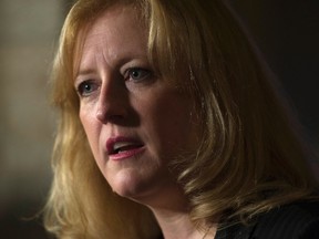 Lisa Raitt speaks with the media in the Foyer of the House of Commons in Ottawa Thursday, February 4, 2016. THE CANADIAN PRESS/Adrian Wyld