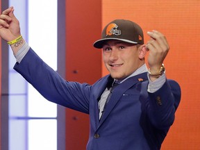 In this May 8, 2014, file photo, Texas A&M quarterback Johnny Manziel reacts after being selected by the Cleveland Browns as the 22nd pick during the first round of the NFL Draft in New York. (AP Photo/Frank Franklin II, File)