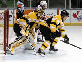 Kingston Frontenacs goalie Jeremy Helvig gets some help from defenceman Chad Duchesne as the Niagara IceDogs' Josh Ho-Sang looks for a rebound during Ontario Hockey League action at the Rogers K-Rock Centre on Jan.16. (Steph Crosier/The Whig-Standard)