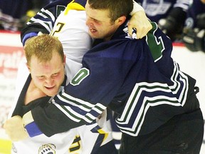Former Belleville Bulls defenceman Ryan Crowther, right, mixes it up with a foe during a Southern Pro Hockey League game for the Asheville (N.C.) Aces.