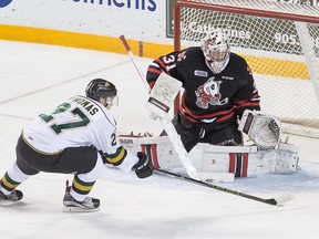 Niagara IceDogs' netminder Alex Nedeljkovic perpares to stop a shot off the stick of London Knights' Robert Thomas during first period OHL action at the Meridian Centre Thursday night. (Colin Dewar Special to The Standard)