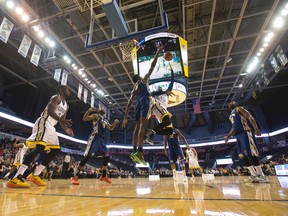 Saint John Mill Rats player Anthony Stover blocks a shot by London Lightning player Warren Ward (10) during their NBL Canada basketball game at Budweiser Gardens in London, Ont. on Thursday February 4, 2016. Craig Glover/The London Free Press/Postmedia Network