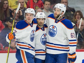 Jordan Eberle celebrates one of his two first-period goals with teammates Connor McDavid, left, and Eric Gryba, right, Thursday in Ottawa. (USA TODAY SPORTS)