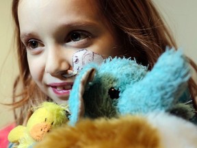 Gianna-Lynn Favilla, 8, who suffers from Crohn’s disease and from primary sclerosing cholangitis (PSC), hugs her stuffed elephant, Ellie, in her Russell home Thursday February 04, 2016.