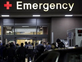 Police officers gather at the emergency entrance of the Lincoln Hospital following the shooting of two New York police officers in the Bronx borough of New York February 4, 2016. REUTERS/Andrew Kelly