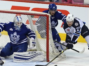 Toronto Marlies goalie Antoine Bibeau (l) and Toronto Marlies defenceman Rinat Valiev stop a scoring attempt by Manitoba Moose left winger Matt Fraser on Thursday. (BRIAN DONOGH/Winnipeg Sun)