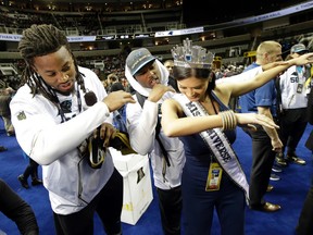 Carolina Panthers' Ryan Delaire and Bene Benwikere dance with Miss Universe during Opening Night for Super Bowl 50 in San Jose on Feb. 1, 2016. (AP Photo/Jeff Chiu)