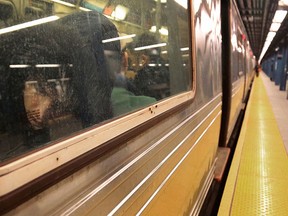 A subway rider, left, leans against the window of an F Train for a snooze, Thursday Feb. 4, 2016, in New York. (AP Photo/Bebeto Matthews)