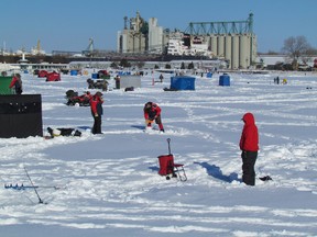 Anglers set up on Sarnia Bay for ice fishing in this 2014 file photo. Ongoing winter warm snaps this year and low ice levels have lead the Bluewater Anglers to cancel their annual ice fishing derby. (File photo)