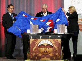 Commissioner Chief Wilton Littlechild (left), Justice Murray Sinclair and Commissioner Marie Wilson unveil the Truth and Reconciliation Commission's final report in Ottawa, Canada, December 15, 2015. REUTERS/Chris Wattie