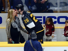Pacific Division forward John Scott kisses his wife after being named most valuable player at the NHL All-Star championship game in Nashville on Jan. 31, 2016. (Mark Zaleski/AP Photo)