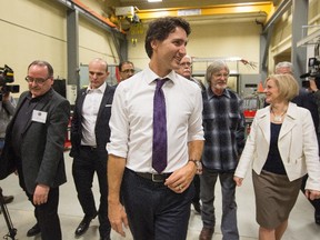 Prime Minister Justin Trudeau, centre, and Alberta Premier Rachel Notley, right, tour the International Brotherhood of Electrical Workers training facility in Edmonton, Alberta, on Wednesday February 3, 2016. THE CANADIAN PRESS/Amber Bracken