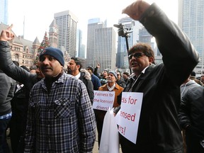 Cabbies yell at Mayor John Tory in front of City Hall on Dec. 9. (Michael Peake/Toronto Sun/Postmedia Network)
